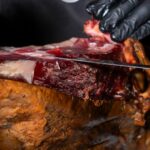 Detalle Maestro cortando Jamón en El Poncho