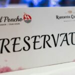 Cartel de mesa reservada con logotipo de El Poncho sobre mantel blanco.