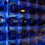 Vinoteca interior de El Poncho con botellas de vino almacenadas en estanterías iluminadas.